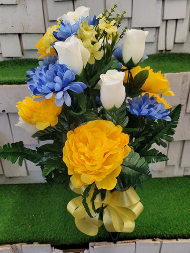 Blue, yellow and white silk cemetery bouquet in a cone vase
