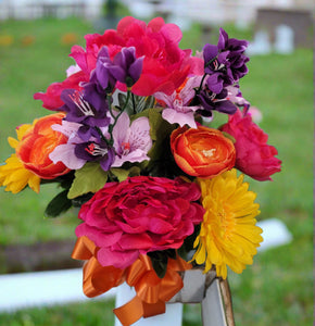 Yellow daisy, pink peony, and orange ranunculus silk cemetery bouquet in a cone vase