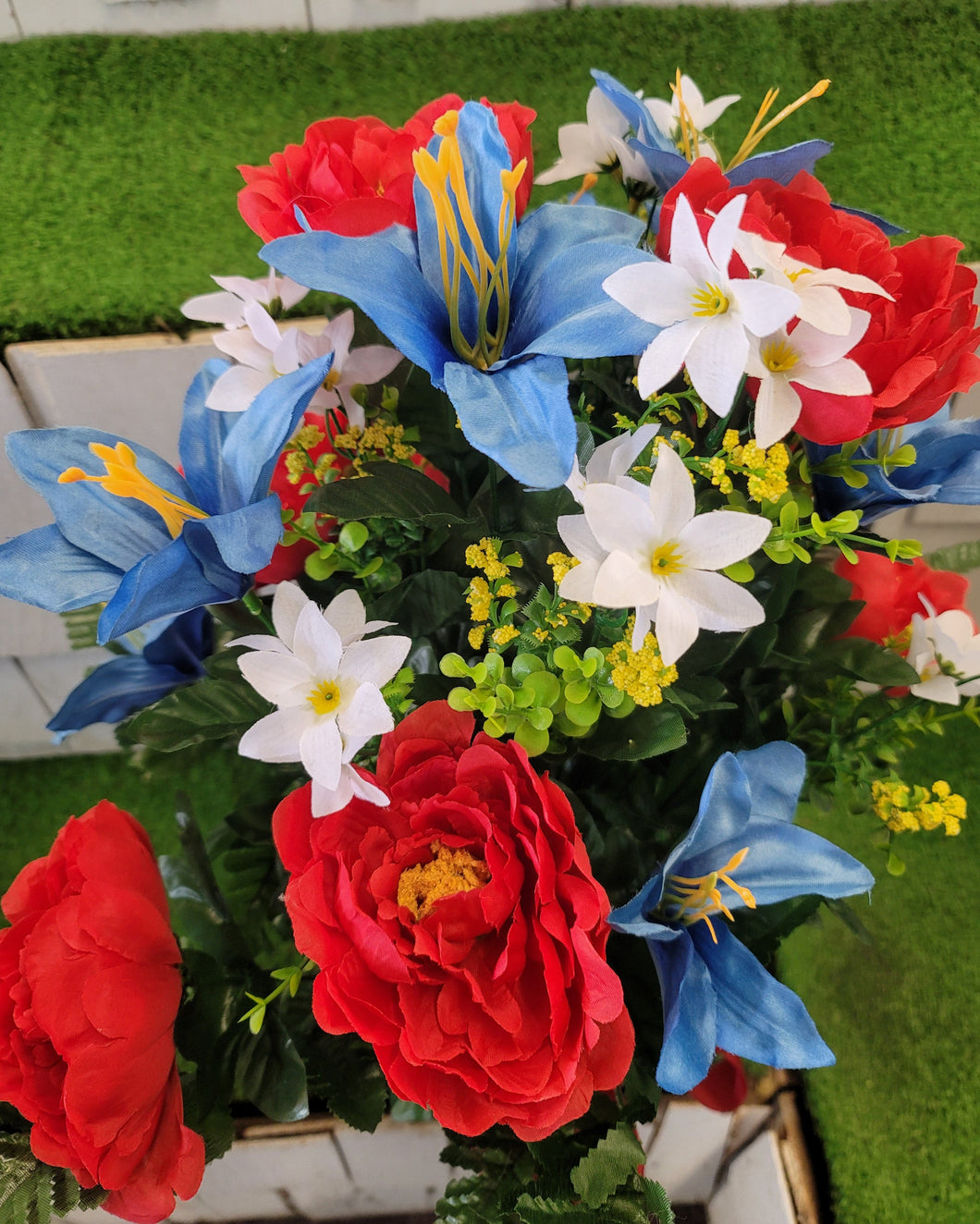 Red peony, white wildflower, and light blue lily silk cemetery bouquet in a cone vase